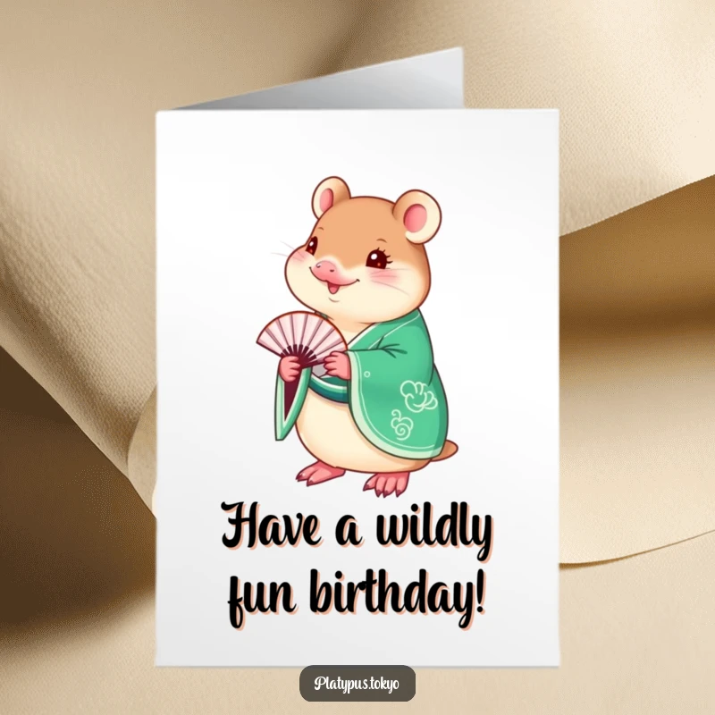 Funny Free Printable Birthday Card: a charming platypus dressed in an emerald green kimono holds a delicate fan.