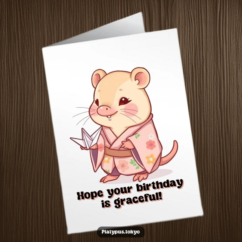 Funny Free Printable Birthday Card: A shy platypus in a floral kimono delicately offers a folded paper crane.