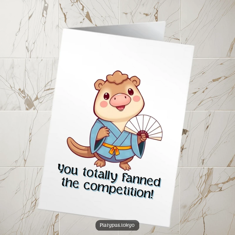 Funny Free Printable Congratulations Card: a cheerful platypus in a blue kimono balances a fan on its bill, celebrating success.