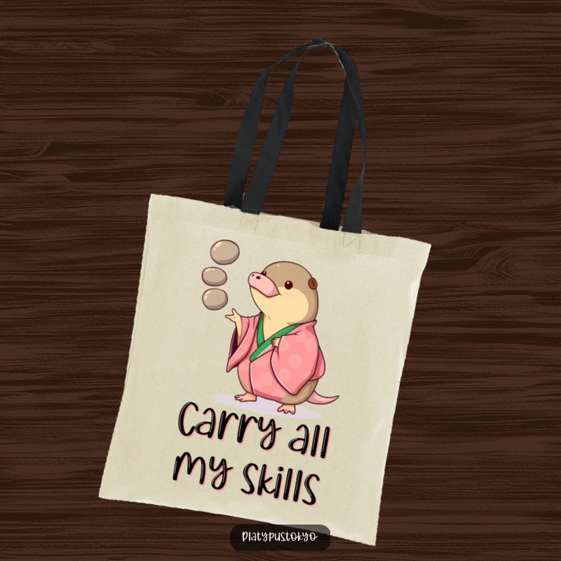 Funny Tote Bag with a platypus in a vibrant kimono playfully juggling three smooth, round pebbles, ready for errands.